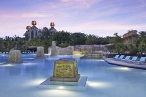 A large pool with lights and rocks in it