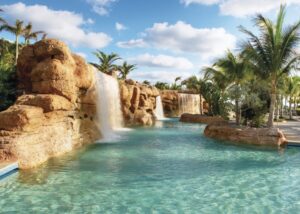 A pool with water falling down the side of it.