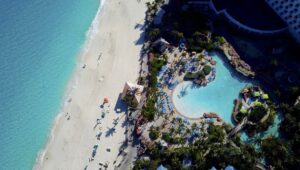 A beach with people swimming in the water.